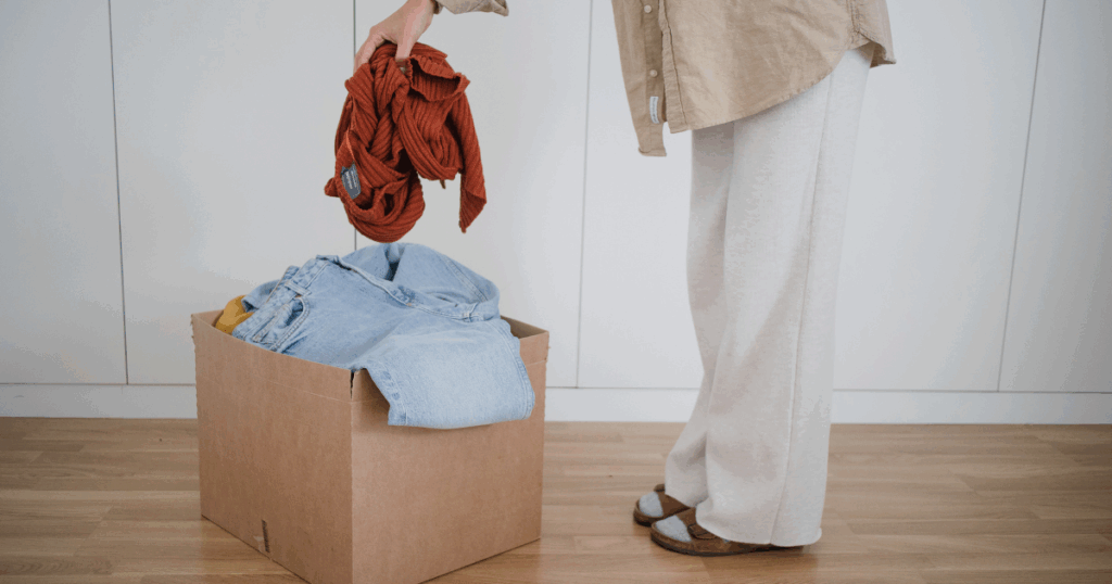 blog-post-pics-1024x538-7 person filling up a box of clothes to donate