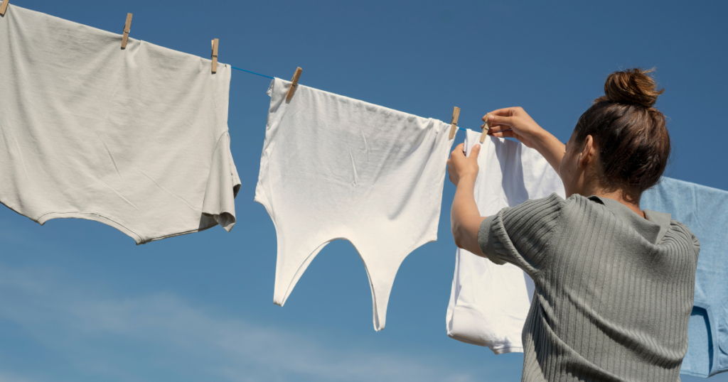 blog-post-pics-copy-1024x538-2 Woman hanging laundry out on a beautiful day. Old fashioned money saving tips are coming back into style in today's economy.