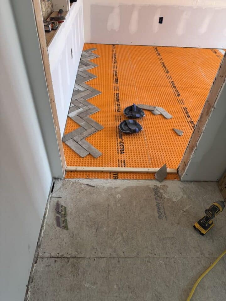 installation of herringbone tile floor