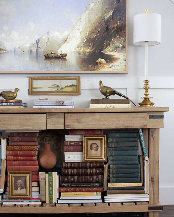 trust-your-gut-in-decorating - living room with piles of books