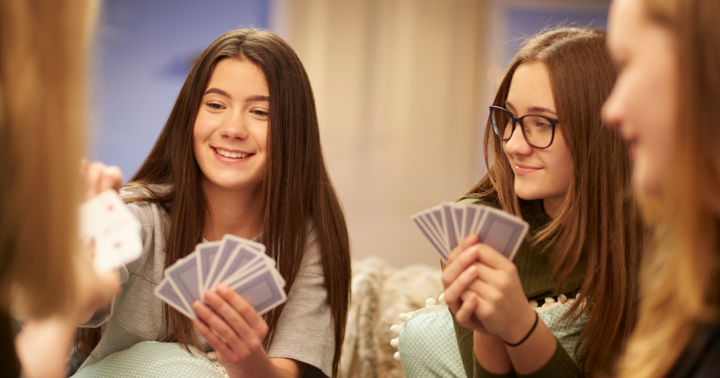 blog-post-pics-1024x538-5 girls playing a card game